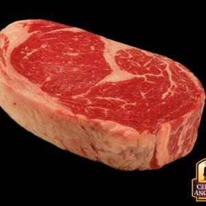 Rib Eye Angus Beef crudo, corte premium con marmoleo visible.